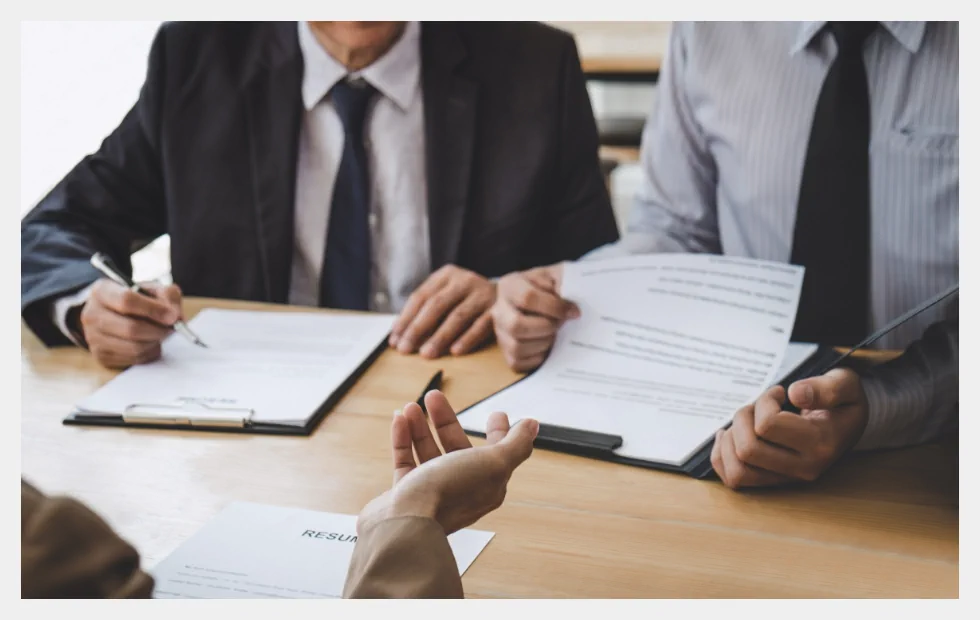 People signing a contract